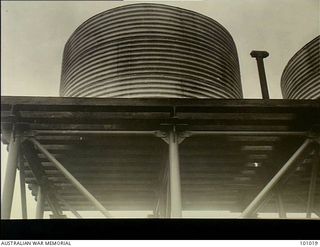 Lae, New Guinea. 1945-05-24. The tie rods on a tubular steel column prefabricated tank stand supporting two 3,000 gallon water tanks