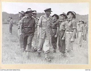 LAE, NEW GUINEA, 1945-12-01. COLONEL G.H.S MORAN ACCOMPANIED BY CAPTAIN A.L. KONG, INSPECTING TROOPS OF 2/77 LIGHT AID DETACHMENT ON THE OCCASION OF THE THIRD ANNIVERSARY OF THE FORMATION OF THE ..