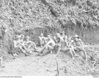 BULLDOG-WAU ROAD, NEW GUINEA, 1943-07-16. ENGINEERS OF THE 1ST AUSTRALIAN PACK TRANSPORT COMPANY HAVING MORNING TEA AT THE 30 MILE POINT