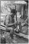 Pounding taro in preparation for ritual before mortuary feast