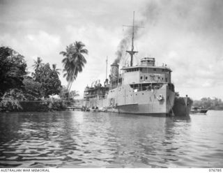 MADANG, NEW GUINEA. 1944-10-31. A THREE-QUARTER BOW VIEW OF THE HMAS PING WO, AN OLD CHINESE RIVER STEAMER NOW USED AS THE OFFICE FOR THE RAN ADMINISTRATION STAFF