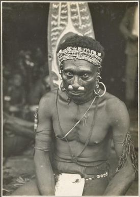 Types from the villages of Urama, Kinomere & Tovei [seated man with a tall mask behind him]