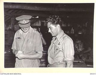 LAE AREA, NEW GUINEA, 1945-06-28. HIS ROYAL HIGHNESS, THE DUKE OF GLOUCESTER, GOVERNOR-GENERAL OF AUSTRALIA (1) BEING SHOWN SOME OF THE HOBBY WORK AT 112 CONVALESCENT DEPOT, BY PTE A. OLIVER (2). ..
