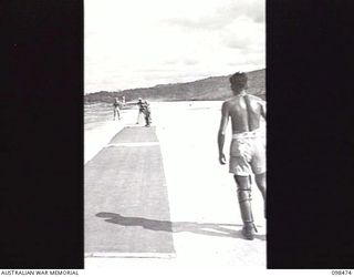 WEWAK AIRSTRIP, NEW GUINEA, 1945-10-30. PRIVATE N. J. CLACK PLAYING A SHOT TO LEG. MEMBERS OF 30TH INFANTRY BATTALION, 8TH INFANTRY BRIGADE, ARE PLAYING A CRICKET MATCH BETWEEN THEMSELVES ON THE ..