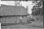 Edwin Cook's house in Kwiop: wife Nancy Cook, rainwater capture system on right