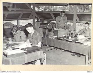 LAE AREA, NEW GUINEA. 1945-08-30. THE ADMINISTRATIVE STAFF, 9 LINES OF COMMUNICATION STATIONERY DEPOT. IDENTIFIED PERSONNEL ARE:- PRIVATE D.J. FLYNN (1); CORPORAL H.J. CAREY (2); WARRANT OFFICER 2 ..