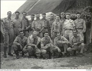 KIRIWINA, TROBRIAND ISLANDS, PAPUA. 1944-01-11. GROUP PORTRAIT OF PILOTS OF NO. 79 (SPITFIRE) SQUADRON RAAF OUTSIDE THEIR ALERT HUT. FRONT ROW: FLYING OFFICER (FO) P. BIRCH, SYDNEY, NSW; FO K. ..
