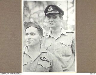 MILNE BAY, PAPUA. 1942-09. FLIGHT-SERGEANT M. BURVILL (LEFT) AND PILOT- OFFICER J.D. RUMBOLD SERVING WITH 76 FIGHTER SQUADRON RAAF IN NEW GUINEA