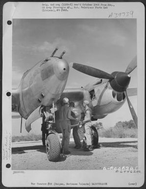 Ground Crew Personnel Load Wing Tank On The Lockheed P-38 'Little Red Head', Isley Field, Saipan, Marianas Islands, November 1944. (U.S. Air Force Number A64462AC)