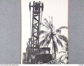 NAGADA, NEW GUINEA. 1944-09-11. QX60471 SAPPER S.N. SAINT, 5TH FIELD COMPANY CHECKING THE CABLES ON A QUICKWAY PILE- DRIVER DURING THE BUILDING OF A NEW BRIDGE ACROSS THE NAGADA RIVER