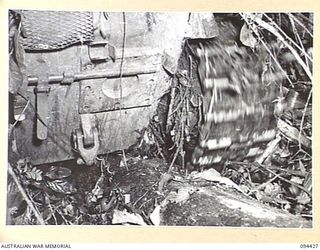 TOROKINA AREA, BOUGAINVILLE. 1945-07-28. AN M24 GENERAL CHAFFEE LIGHT TANK "BELLIED" ON A FALLEN TREE WHICH MEASURES APPROXIMATELY TWO FEET IN DIAMETER. THE COMMANDER, TAKING PART IN TESTS ..