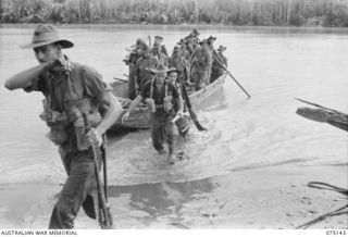 HANSA BAY-BOGIA HARBOUR, NEW GUINEA. 1944-08-09. TROOPS OF NO. 13 PLATOON, C COMPANY, 30TH INFANTRY BATTALION USING A CAPTURED JAPANESE BOAT TO CROSS THE MOUTH OF THE RAMU RIVER WHILE ON THEIR WAY ..