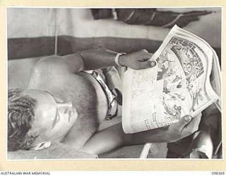 WEWAK, NEW GUINEA. 1945-10-29. SERGEANT N.S. BRAY (1), 1 BROADCASTING STATION, AUSTRALIAN ARMY AMENITIES SERVICE, A MEMBER OF RADIO STATION 9AJ, TAKING TIME OFF TO RELAX