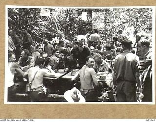 FINSCHHAFEN, NEW GUINEA. 1943-12-25. A GENERAL VIEW OF THE MEN'S MESS AT HEADQUARTERS 9TH DIVISION DURING THE CHRISTMAS DINNER