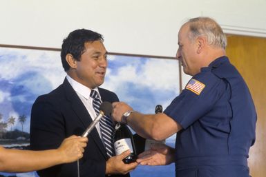 Major General (MGEN) Donald D. Brown, commander, 22nd Air Force, exchanges gifts with Samoan Lieutenant Governor Eni Hunkin. Brown is visiting Samoa after a 22nd Military Airlift Squadron aircraft delivered an emergency electrical generator and equipment to Pago Pago