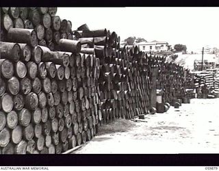 ENOGGERA, QLD. 1943-11-02. PETROL DRUMS RETURNED TO NO. 1 AUSTRALIAN SALVAGE DEPOT FROM NEW GUINEA. THESE DRUMS WILL BE REPAIRED AND TESTED BEFORE BEING RETURNED TO UNITS