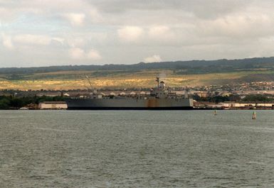 A port beam view of a Military Sealift Command supply ship docked in port