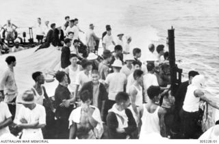 NAURU, PACIFIC ISLANDS. 1942-02. CIVILIANS EVACUATED FROM NAURU AND OCEAN ISLAND BY THE FREE FRENCH DESTROYER LE TRIOMPHANT ON THE SHIP'S QUARTERDECK. (NAVAL HISTORICAL COLLECTION)