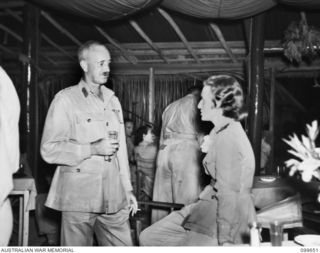 LAE, NEW GUINEA. 1946-01-24. BRIGADIER E. L. SHEEHAN, BRIGADIER GENERAL STAFF, FIRST ARMY, TALKING TO A MEMBER OF THE AUSTRALIAN ARMY NURSING SERVICE IN THE OFFICERS' MESS AT THE AUSTRALIAN ARMY ..