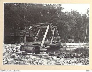 JACQUINOT BAY, NEW BRITAIN. 1945-04-08. A 75-FOOT TRUSS SUSPENSION TYPE BRIDGE BUILT OVER A SMALL CREEK NEAR THE TAUT RIVER BY 13 FIELD COMPANY, ROYAL AUSTRALIAN ENGINEERS. IT HAS A SPAN OF 54 FEET ..