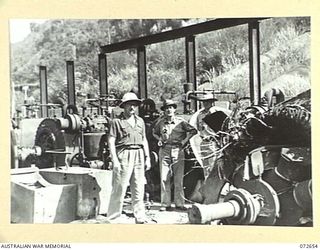 WAU - BULOLO ROAD, NEW GUINEA. 1944-04-26. THE HONOURABLE E.J. WARD, MINISTER FOR EXTERNAL TERRITORIES IN THE AUSTRALIAN GOVERNMENT (1), WITH MR J. R. HALLIGAN, SECRETARY, DEPARTMENT OF EXTERNAL ..