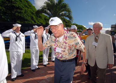 U.S. Navy USS ARIZONA survivor, Vincent Vlach, returns a salute as he makes his way through an honor cordon for USS ARIZONA survivors. One hundred Sailors and Marines assigned to the Arleigh-Burke class guided-missile destroyers USS PAUL HAMILTON (DDG 60) and USS RUSSELL (DDG 59) and part of Combat Service Support Group 3, made up the honor cordon, which rendered honors to the survivors as they entered the USS ARIZONA Memorial Visitors Center at Pearl Harbor, Hawaii, on Dec. 5, 2006. (U.S. Navy PHOTO by Mass Communication SPECIALIST 1ST Class James E. Foehl) (Released)