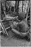 Pig festival, stake-planting, Tuguma: man bespells bamboo sections