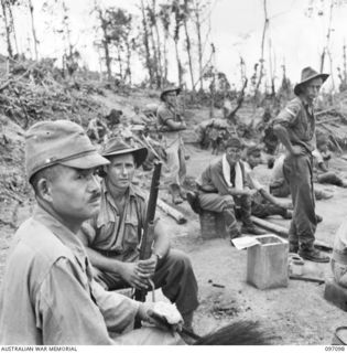 MOUNT SHIBURANGU, WEWAK AREA, NEW GUINEA. 1945-09-21. MAJOR GENERAL ARAKI OF 18 JAPANESE ARMY, BEING GUARDED BY AN AUSTRALIAN SOLDIER, AT A CONTROLLING POINT AT MAKOW ON THE TOP OF MOUNT ..