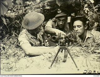 TOROKINA, BOUGAINVILLE ISLAND, SOLOMON ISLANDS. C. 1945-02-23. DURING INSTRUCTIONS ON BREN GUNS 12573 FLIGHT LIEUTENANT L. BLOOMFIELD, ST KILDA, VIC, DIRECTS 137592 LEADING AIRCRAFTMAN R. MANCELL, ..