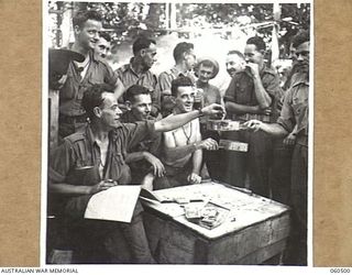 FINSCHHAFEN AREA, NEW GUINEA. 1943-11-13. THE DRAWING OF THE MELBOURNE CUP SWEEP AT HEADQUARTERS, 9TH AUSTRALIAN DIVISION