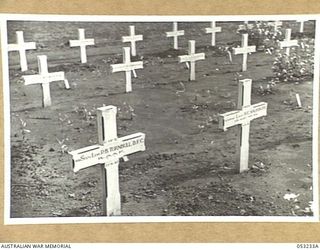 MILNE BAY, NEW GUINEA. 1943-06-27. AIR FORCE AND ARMY PERSONNEL REST SIDE BY SIDE IN THE MILNE BAY WAR CEMETERY. GRAVES ARE THOSE OF SQUADRON LEADER P.B. TURNBULL DFC, RAAF AND QX4387 LIEUTENANT ..
