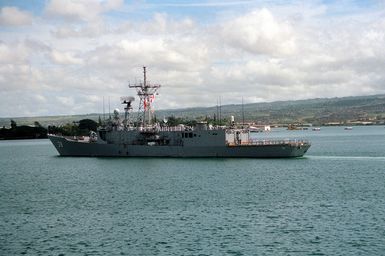 Sailors man the rails aboard the guided missile frigate USS CURTS (FFG-38) as the vessel passes the USS ARIZONA Memorial