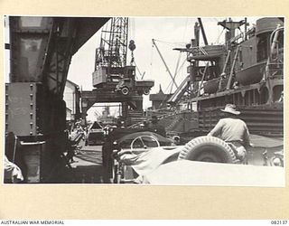 TOWNSVILLE, QLD. 1944-10-18. TRANSPORT VEHICLES OF FIRST ARMY BEING LOADED INTO THE HOLDS OF THE LIBERTY SHIP SS JAMES OLIVER FOR EMBARKATION TO LAE, NEW GUINEA