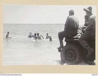 BOIKEN, NEW GUINEA, 1945-07-18. GUN CREWS OF 2/2 FIELD REGIMENT, ROYAL AUSTRALIAN ARTILLERY, PLAYING WATER-POLO WHILE OFF DUTY