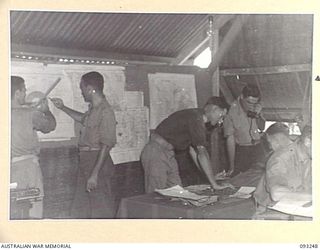 CHABAI/SORAKEN AREA, BOUGAINVILLE, 1945-06-19. THE INTELLIGENCE STAFF AT WORK AT HQ 11 INFANTRY BRIGADE