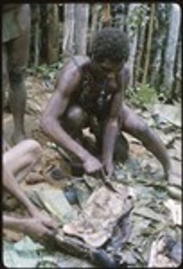 Man cutting a slab of pork