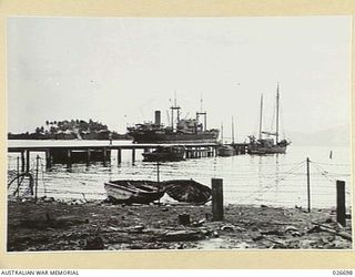 MILNE BAY, PAPUA. 1942-09. JETTY AT MILNE BAY FORMERLY OWNED BY LEVER BROTHERS PLANTATION, WHICH IS USED BY THE SMALLER CRAFT FOR UNLOADING