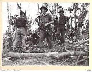 WEWAK AREA, NEW GUINEA, 1945-06-16. LT-COL W.S. HOWDEN, COMMANDING OFFICER, 2/8 INFANTRY BATTALION (1), INSPECTING THE AREA ON HILL 2 JUST TAKEN BY B COMPANY AFTER THEIR SUCCESSFUL ATTACK. ..
