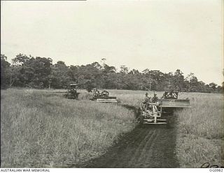 AITAPE, NORTH EAST NEW GUINEA. C. 1944-04. NO. 7 MOBILE WORKS SQUADRON RAAF GOES INTO ACTION WITH BULLDOZERS, TRACTORS, GRADERS, ROLLERS AND OTHER HEAVY EQUIPMENT WHICH WERE LANDED WITH THE ..