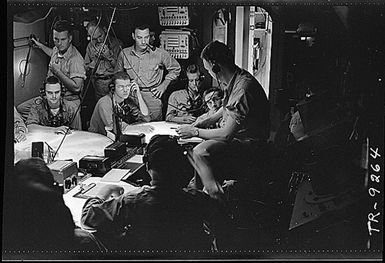 Lt. Cdr. A.F. Fleming, fighter director, in plot room of USS Lexington (CV-16) during a strike in the Gilbert & Marshall Islands.