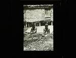 Two men plaiting coconut leaves for walls of house, Rabaul or Gazelle Peninsula, c1915 to 1921