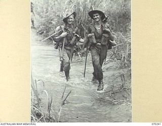 FARIA VALLEY, NEW GUINEA. 1944-02-09. PERSONNEL OF "B" COMPANY, 2/10TH INFANTRY BATTALION, CROSS THE FARIA RIVER ON THE JOURNEY TO THE RAMU VALLEY AFTER BEING RELIEVED BY THE 58/59TH INFANTRY ..