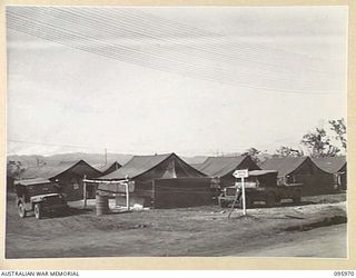 CAPE WOM, WEWAK AREA, NEW GUINEA. 1945-09-01. ENTRANCE TO DENTAL CENTRE AND TENT LINES OF 2/4 DENTAL UNIT, ATTACHED HEADQUARTERS 6 DIVISION