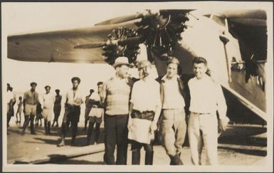 Portrait of James Warner, Charles Kingsford Smith, Charles Ulm and Harry Lyon in front of The Southern Cross plane before leaving Suva, June 1928