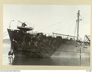 PORT MORESBY, PAPUA, 1944-03-21. THE BOW SECTION OF THE OIL TANKER EMPIRE SILVER, BERTHED AT THE OIL WHARF WITH SUPPLY FOR THE 1ST BULK PETROLEUM STORAGE COMPANY, (NEW GUINEA FORCE). JOINS WITH ..