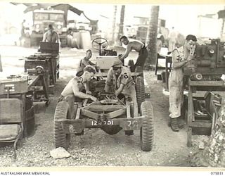 ALEXISHAFEN, NEW GUINEA. 1944-09-13. TROOPS OF THE 133RD BRIGADE WORKSHOPS, DISMANTLING MOTOR VEHICLES IN THE UNIT WORKSHOPS. IDENTIFIED PERSONNEL ARE:- NX156593 STAFF SERGEANT J.M. FENWICK (1); ..