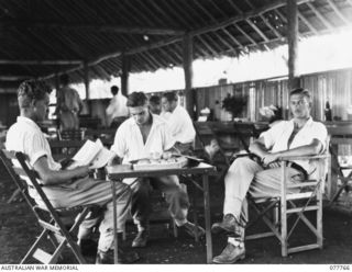 Australian troops relaxing in the Australian Red Cross Society Rest Hut at the 2/7th Australian General Hospital. Identified personnel, from left to right are: NX140976 Corporal Laurance Kendall ..