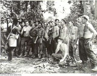 IP RIVER AREA, NEW BRITAIN. 1945-02-07. TROOPS OF THE 14/32ND PIONEER BATTALION, WHO HAVE BUILT ALL THE BRIDGES OVER THE RIVERS AND CREEKS BETWEEN THE SAMPUN AND KEMKONG RIVERS CHATTING WITH A ..