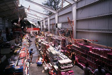 Workers take stock of the items lost when Typhoon Omar ripped the roof from the newly opened toy section of the Navy exchange. Omar struck on August 29th, causing severe damage to Andersen; Naval Station, Guam; and the surrounding area