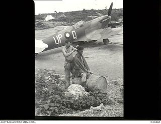 KIRIWINA, TROBRIAND ISLANDS, PAPUA. 1944-01-11. RIGGERS ON STAND-BY DUTY NEAR THEIR SPITFIRE AIRCRAFT, CODE UP-Q, OF NO. 79 (SPITFIRE) SQUADRON RAAF. LEADING AIRCRAFTMAN (LAC) G. E. STEVENS OF ..